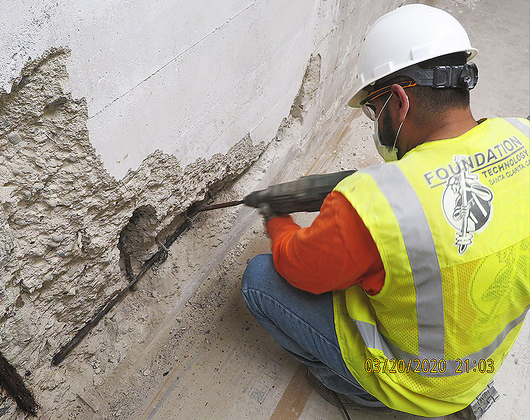 crew member repairing corrosion in rebar at a commercial bank vault