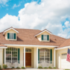 2 Story home with large garage under blue sty with some clouds