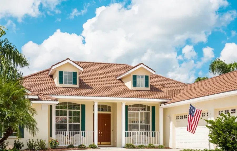 2 Story home with large garage under blue sty with some clouds
