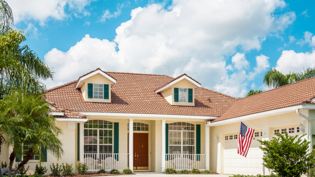 2 Story home with large garage under blue sty with some clouds