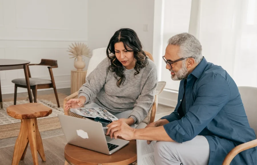 Man and Women looking at laptop discussing foundation work