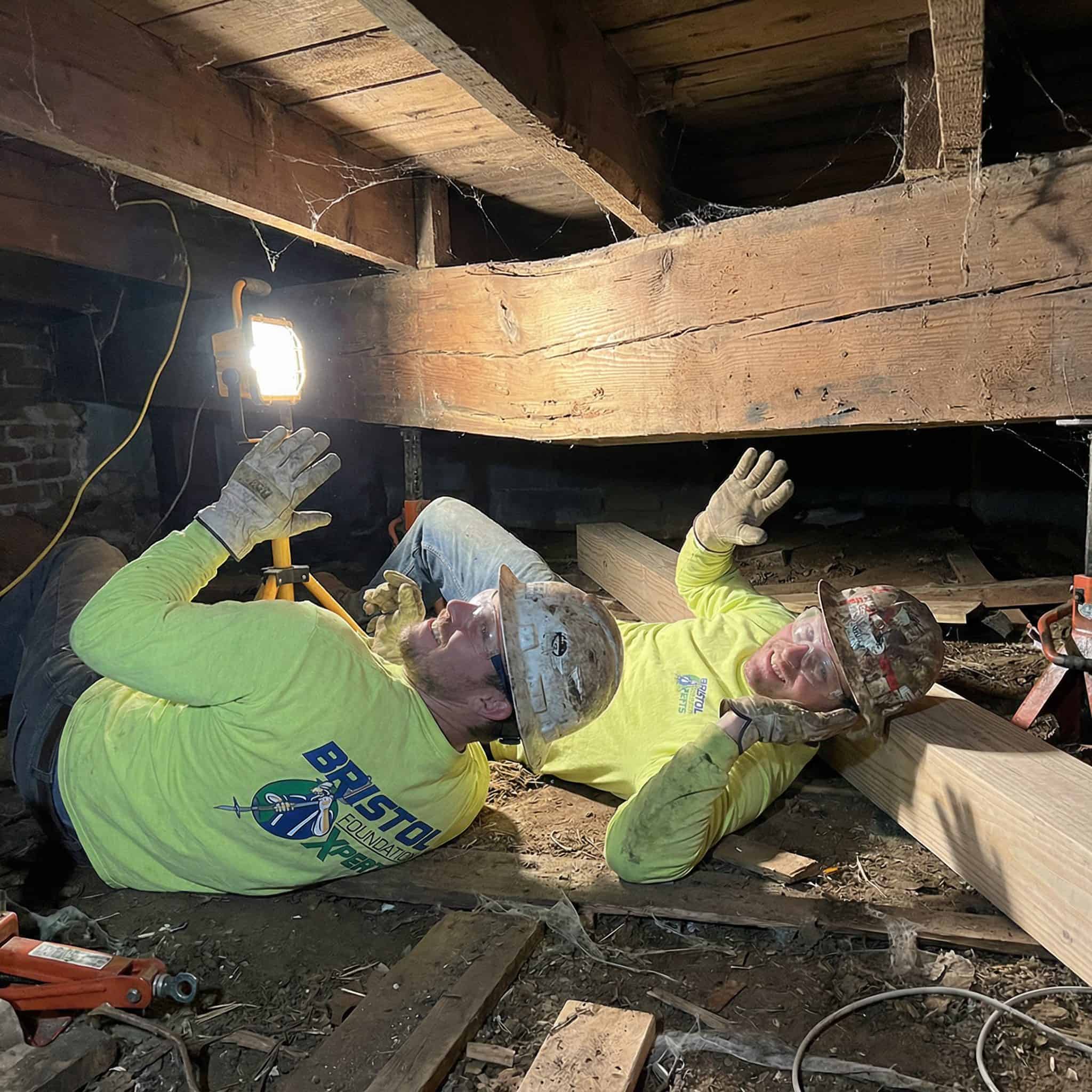 Bristol FX foundation repair crew replacing a crawlspace beam during structural rehabilitation in California