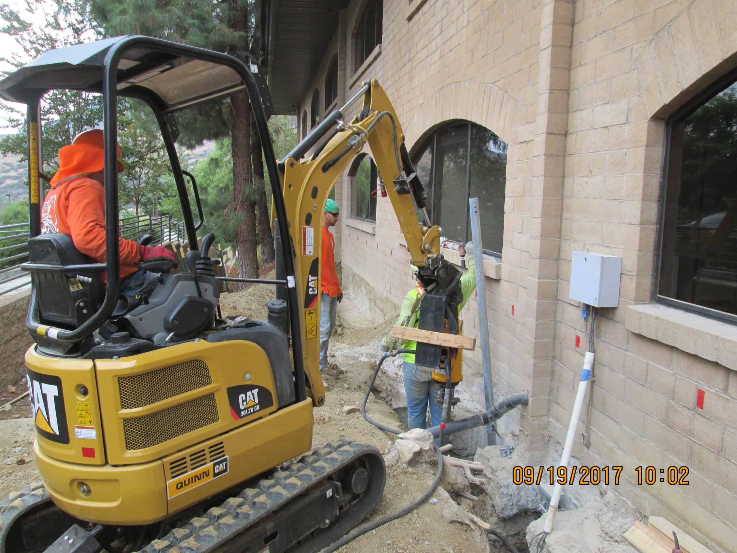 View of steep, triangular rooftops against a blue sky with clouds.