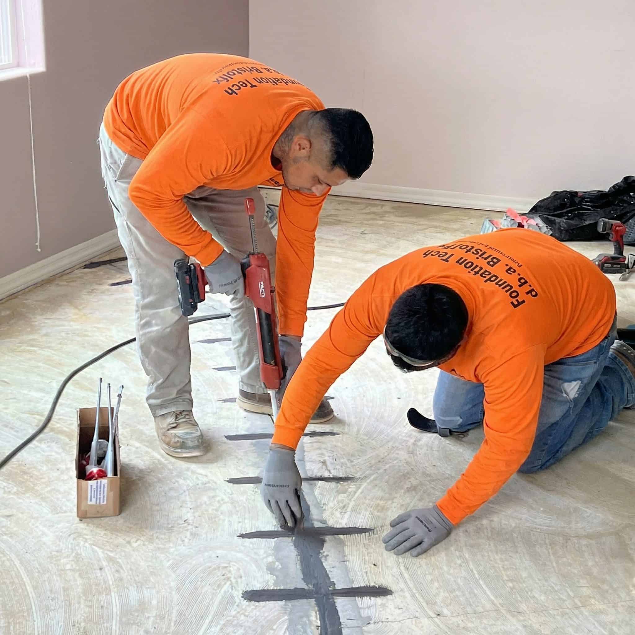 Crack injection and carbon fiber staples repairing a slab foundation