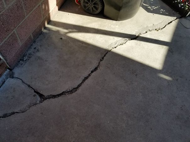 Cracked concrete floor slab being prepared for repair