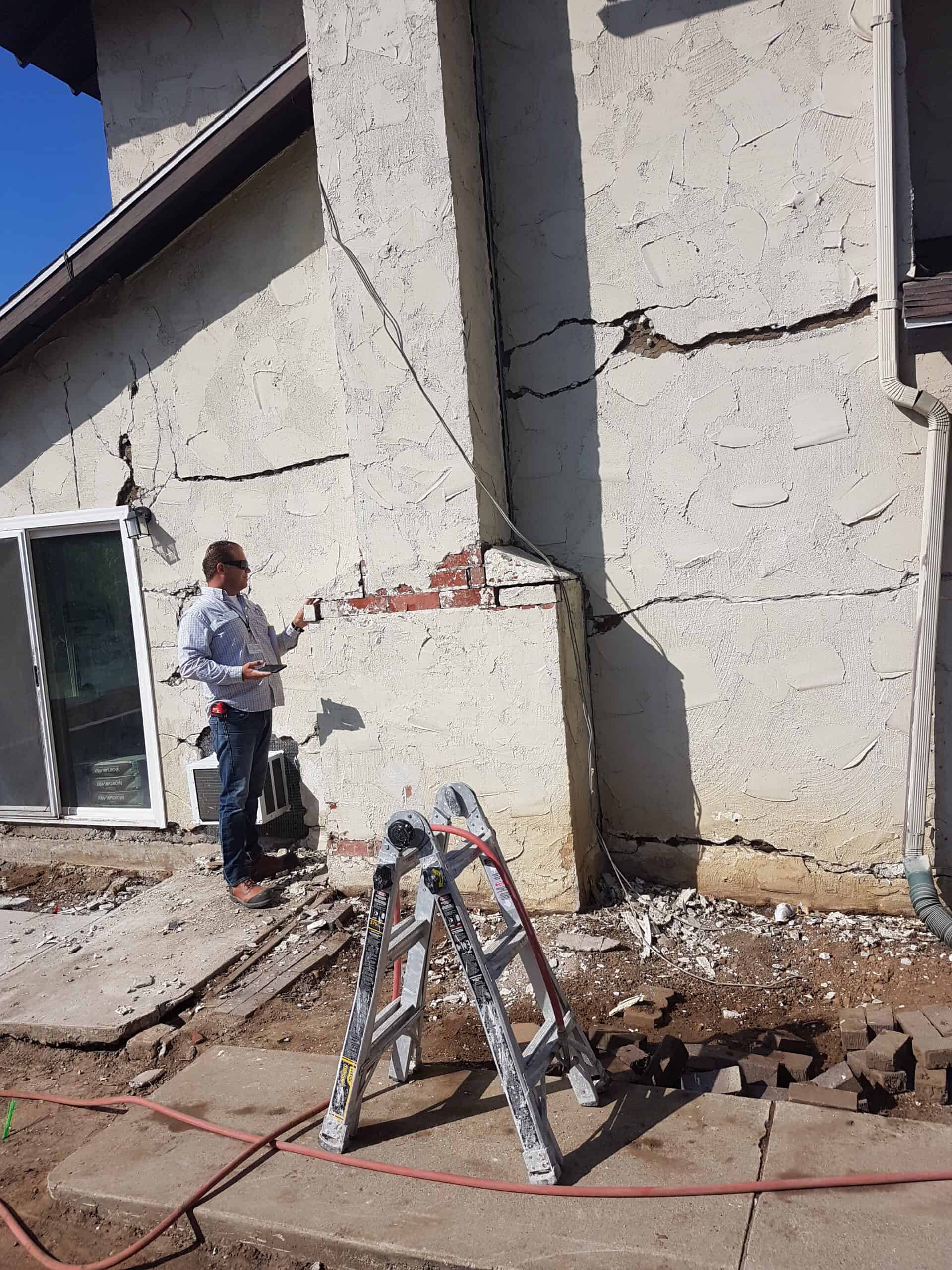 View of steep, triangular rooftops against a blue sky with clouds.