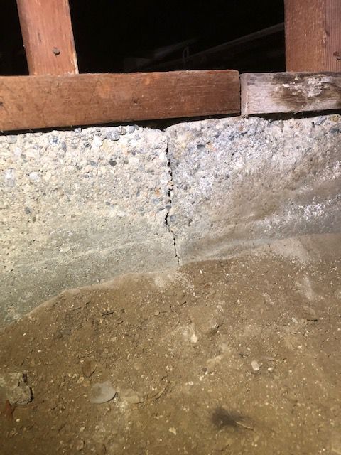 Foundation stemwall crack showing sill plate settlement — a sign of active foundation movement.