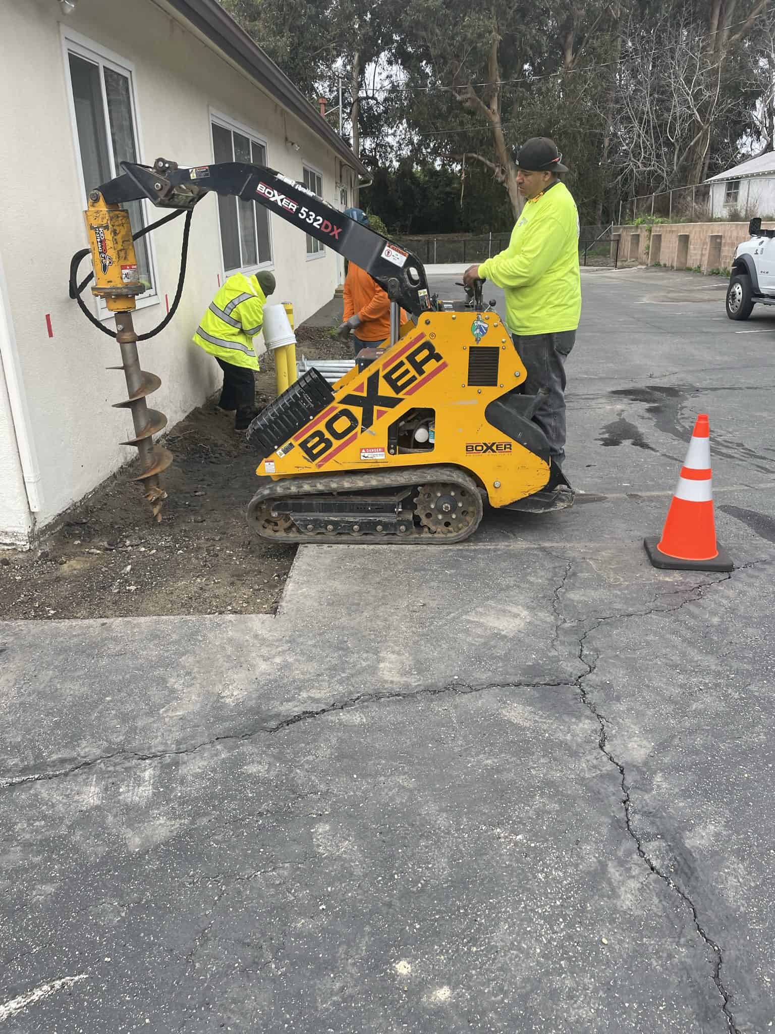 View of steep, triangular rooftops against a blue sky with clouds.