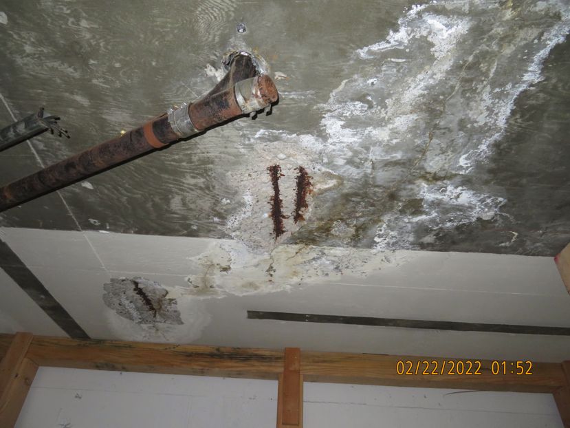Corroded rebar exposed in a parking structure — evidence of serious corrosion damage.