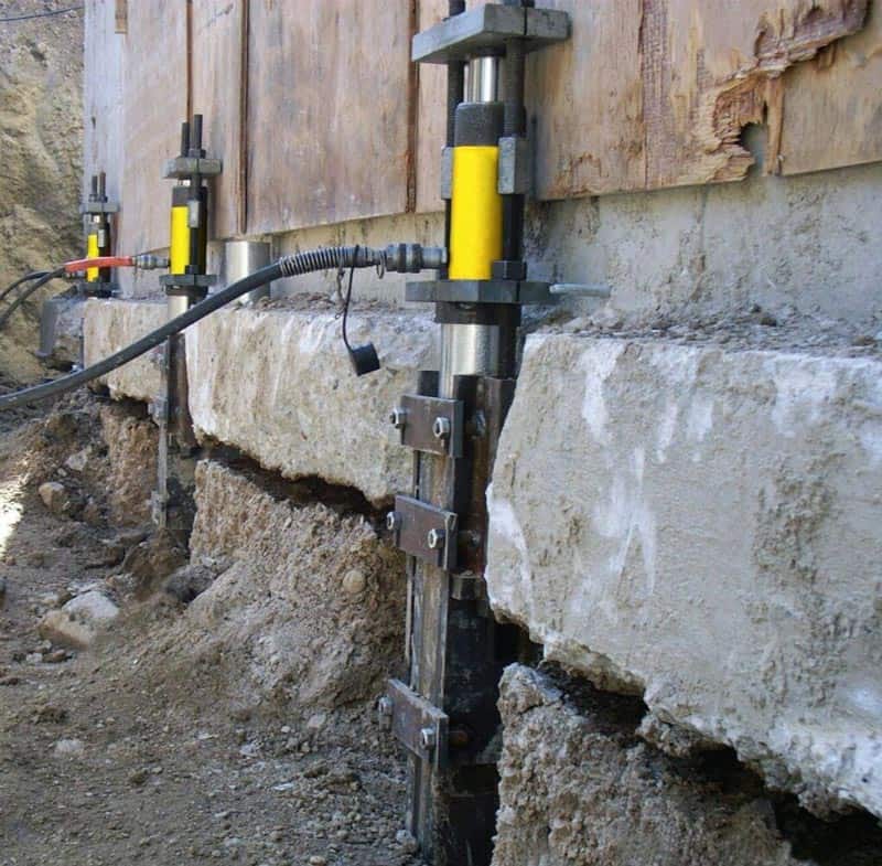 Foundation repair with lift cylinders.
