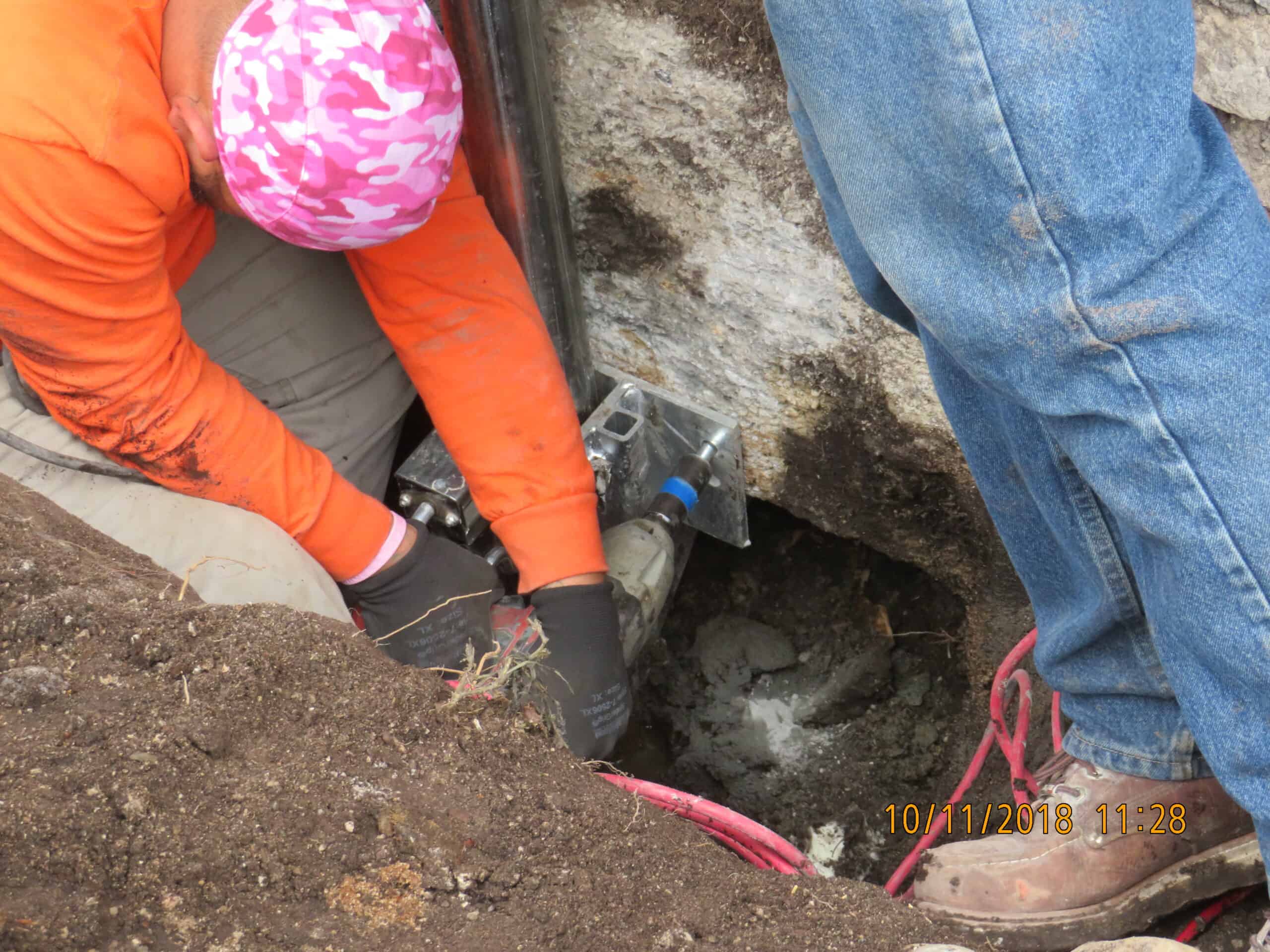 View of steep, triangular rooftops against a blue sky with clouds.