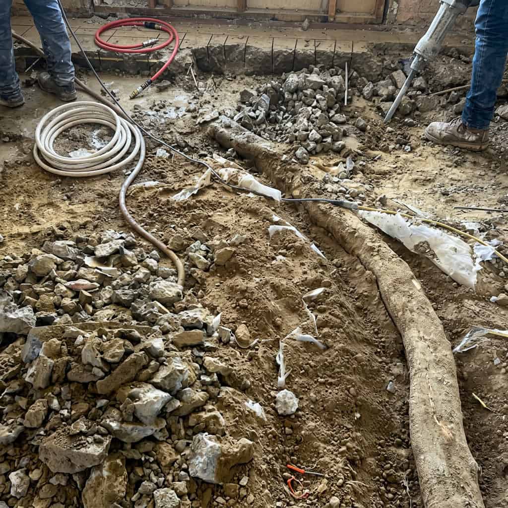 Large Sycamore root removed from beneath Thousand Oaks living room slab — root grew under concrete for years before discovery