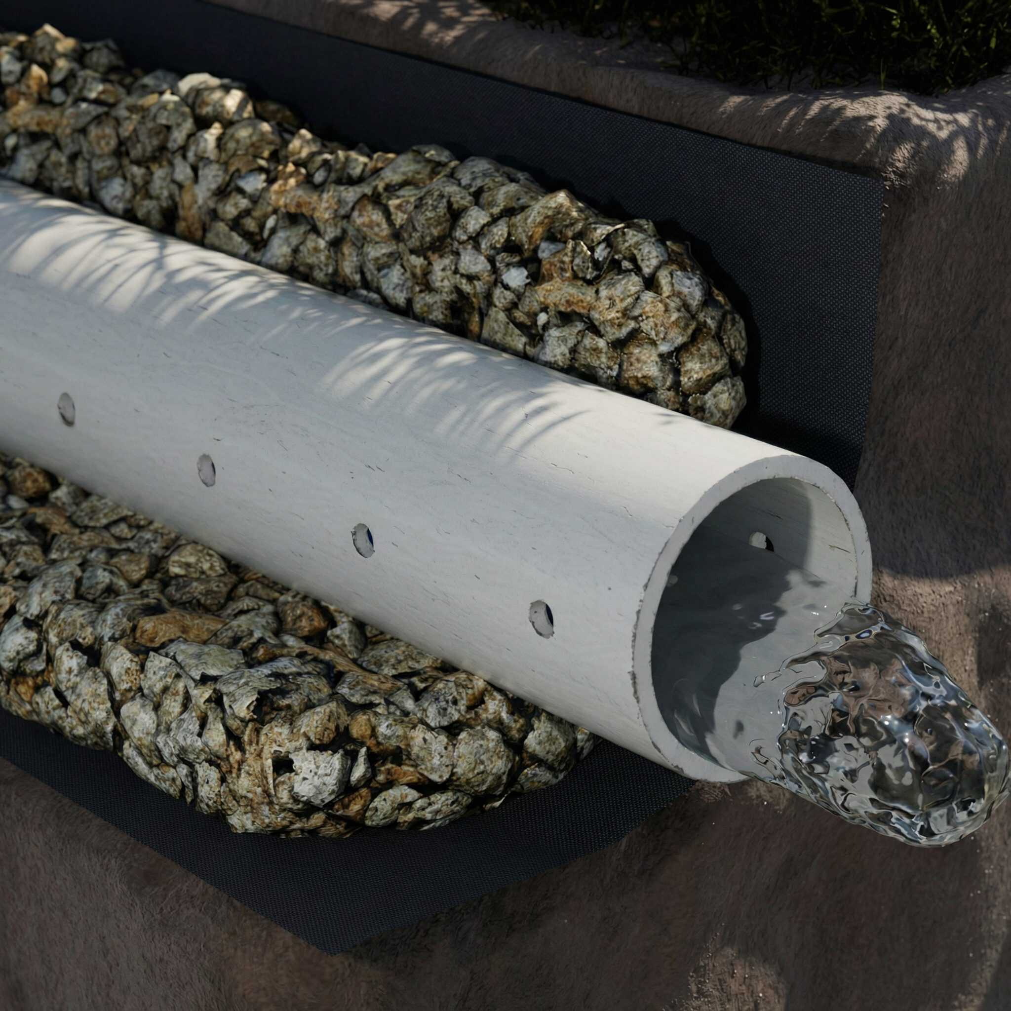 Close up of a french drain pipe with water flowing through it