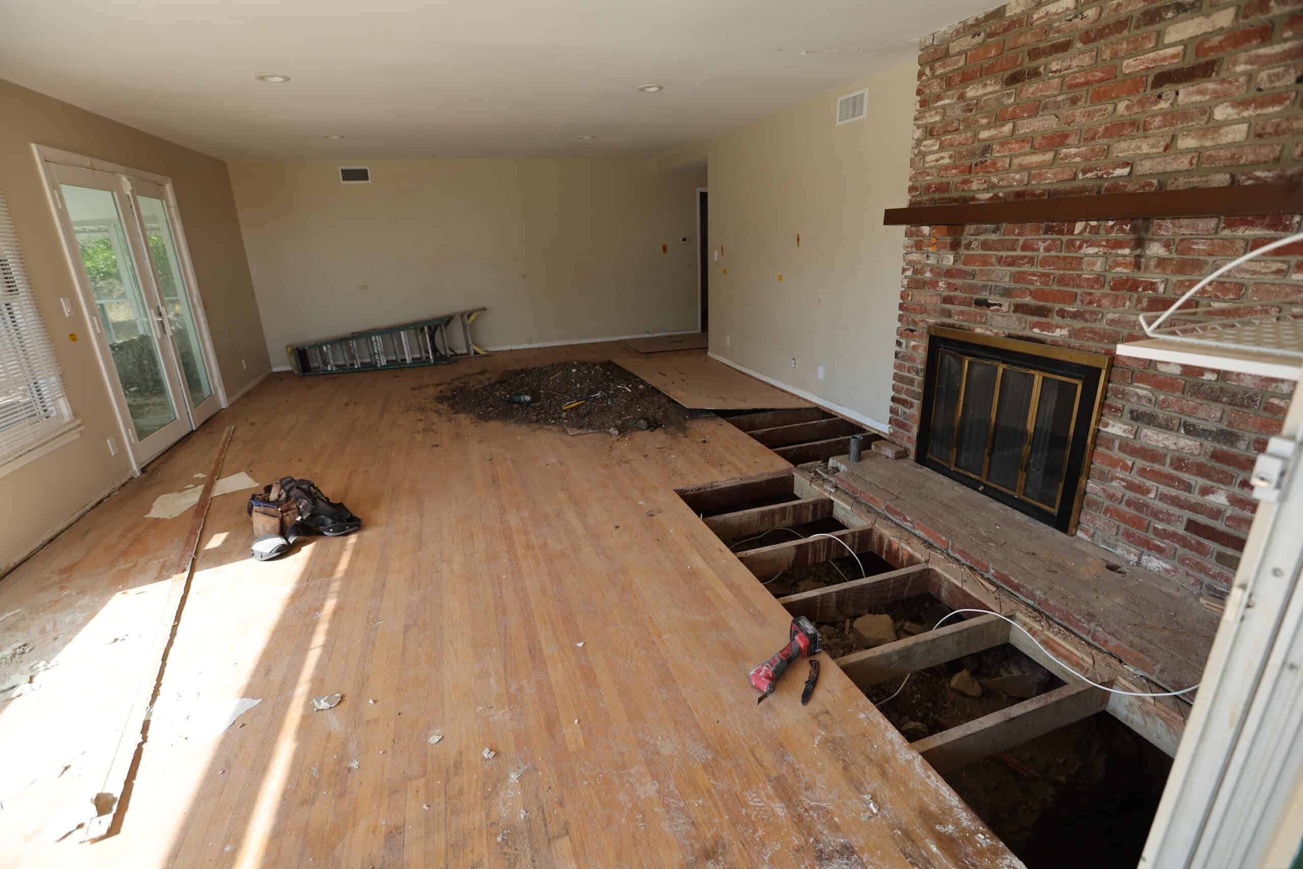 Major residential foundation repair project with the structure shored and the original foundation removed for replacement